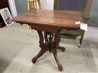 Top and side view of the wooden antique Victorian side table showing the rectangular top and carved apron underneath.