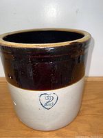 Front view of the crock showing the blue heart stamp with number 2.
