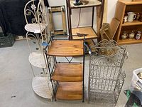 Three different vintage plant stands together, showing size, design, and condition including wear.