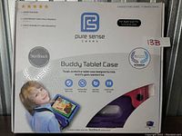 Front view of the Buddy Tablet Case packaging showing product name, features, and child-friendly design image.