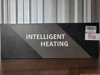 Photo of the large black box labeled 'INTELLIGENT HEATING'. This is the packaging for the heated mitts set.