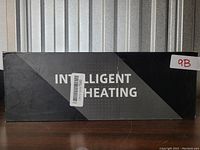 Photo of the front of the boxed heated mitts package showing the text Intelligent Heating.