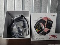 Box containing ZRB smart watch with black strap and accessories inside the packaging.