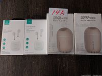 Photo of two boxed bottle humidifiers and two boxed TWS earbuds, all new in packaging.