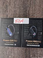 Front view of Power Q20 Pro and Power HBQ Pro earbud packaging showing branding and design.