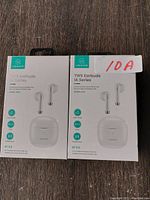 Front view of two identical boxed USAMS TWS Earbuds IA Series Bluetooth 5.0 wireless earbuds in white, showing product name and image.