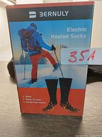 Front view of Bernuly electric heated socks box showing branding and product image of socks with skier.