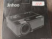 Black box showing line drawing of Jinhoo digital projector and brand name.