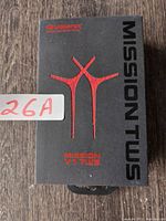 Front of black and red box for Mission V1 TWS wireless earbuds with prominent branding and model designation.