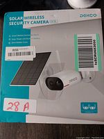 Box front showing DEKCO solar wireless security camera with solar panel and branding details.