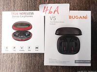 Photo of the front of the earbud packaging showing the charging case and earbuds inside, with branding and product name