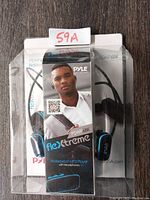 Front view of Pyle Flexxtreme PSWP6BK Waterproof MP3 Player packaging with headphones, showing product branding and image of included earbuds.