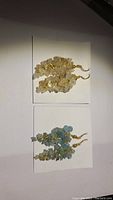 Two pairs of brass earrings with natural gemstones (blue apatite and crystal quartz) placed on white cards; photographed to show both pairs.
