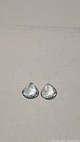 Top-down view of two pear cut aquamarine gemstones, soft blue color, 6x6mm each