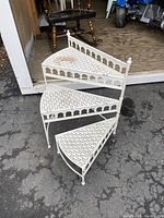 Full side view of the 3-tier adjustable aluminum plant stand, showing its triangular lattice shelves and decorative arches.