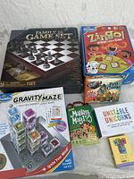 Photo showing all 7 games in the bundle arranged on a gray surface