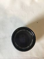 Top front view of the Pentax Asahi 50mm f/2 SMC M lens showing lens details and markings.