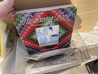 The Sewing Book with a colorful quilt pattern cover and practical sewing illustrations on front.