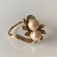 Front angle showing twin pearls and leaf setting