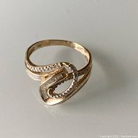 Ring top view showing swirl design and diamond settings