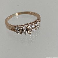 Front view of ring showing two-row staircase of fourteen round brilliant diamonds