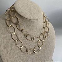 Necklace displayed on fabric bust showing overall length and link design.