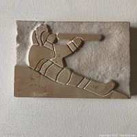 Main photo of the marble plaque carving showing the Inuit figure and clear signature "Bernett."