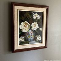 Overall view of framed oil painting hanging on wall