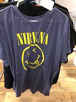 Nirvana T-shirt with yellow smiley face logo on front