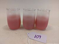 Set of three pink Blendo juice tumblers with ombre fade from pink to clear, shown side by side.