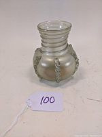 Front angle view of the antique iridescent blown glass vase with applied spiral glass decoration and ribbed flared neck.