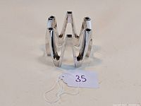 Silver plated mid century Dansk five-arm candelabra photographed on white background, angled slightly to show its form and condition.