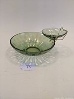 Green transparent glass chip and dip set with a petal design, showing the larger bowl with a smaller dip bowl attached by a metal bracket on the side.