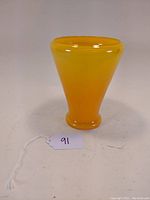 Front view of mid century glass vase showing yellow to orange gradient color and shape