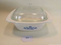 Vintage Corning Ware 4 quart Dutch oven showing side view with blue cornflower pattern and clear glass lid in place