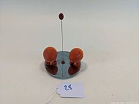 Front view of the Alessi Lilliput salt and pepper shakers on round tray showing full set