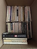 Image showing two rows of Agatha Christie paperback books and four hardcovers at bottom including The Labours of Hercules and Mrs McGinty's Dead.