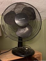 Black Honeywell oscillating table fan showing front view with visible logo on blade hub.