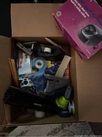 Box photo showing electric pencil sharpener in original box along with vintage staplers, tape dispensers, hole punchers, correction tape, sticky notes, and other office supplies.