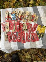 Full overview of assorted new router bits and dies spread on fabric with leaves background