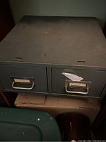 Photo of two vintage metal file drawers with two drawers each, showing wear and surface dirt.