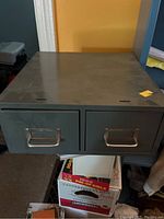 Photo of one vintage metal file drawer unit with two drawers, showing metal handles and dark gray finish