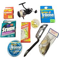 Photo of multiple fishing lines, lure packaging, and metal fishing lures with packaged rod holder accessory.
