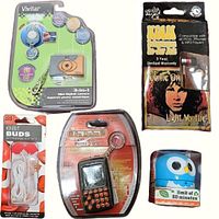 Full lot content including Vivitar mini digital camera, Sudoku game, The Doors wired earbuds, owl timer, and red lips wired earbuds all in original packaging.
