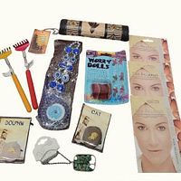 Full lot showing hair treatments, back scratchers, worry dolls, Evil Eye wall art, dolphin and cat stone tokens, and rain stick.