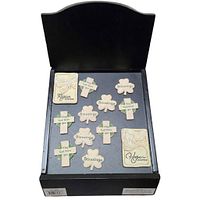 Top view of 12 new Celtic Cross and shamrock magnets arranged on a black wooden display box with curved back panel