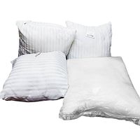 Four pillow inserts laid out showing size and texture, three with white striped fabric and one bag of fiberfill insert.