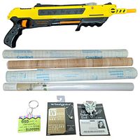 Photo of Bug-A-Salt insect killing tool, two keychains, prayer card necklace, metal butterfly badge reel, and white vinyl/paper rolls.