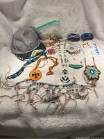 Full lot overview showing all beaded items including hat, necklaces, bracelets, and bags of beads.