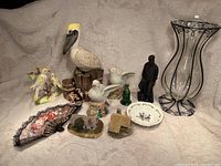 Overview of all decorative items including vase, ceramic birds, miniature houses, fan, and small plates.